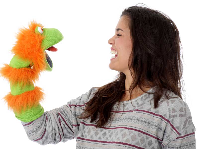 girl playing with a glove puppet on her hand having fun