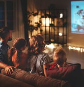 family watching projection screen
