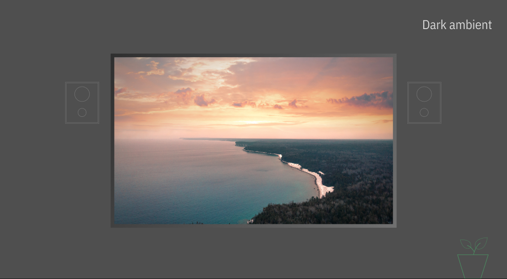 Large television screen displaying a coastline and sunset