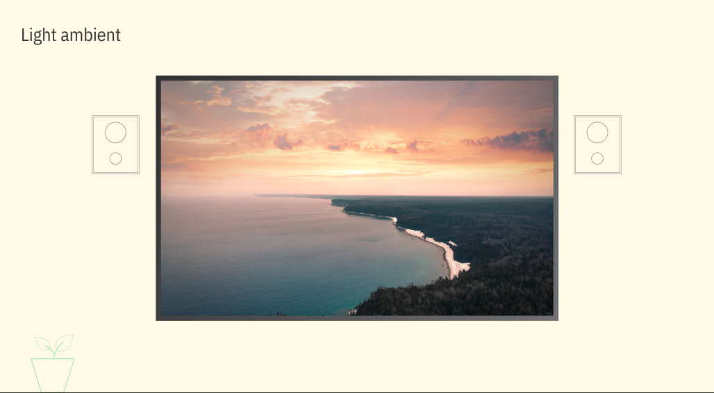 Large television screen displaying a coastline and sunset