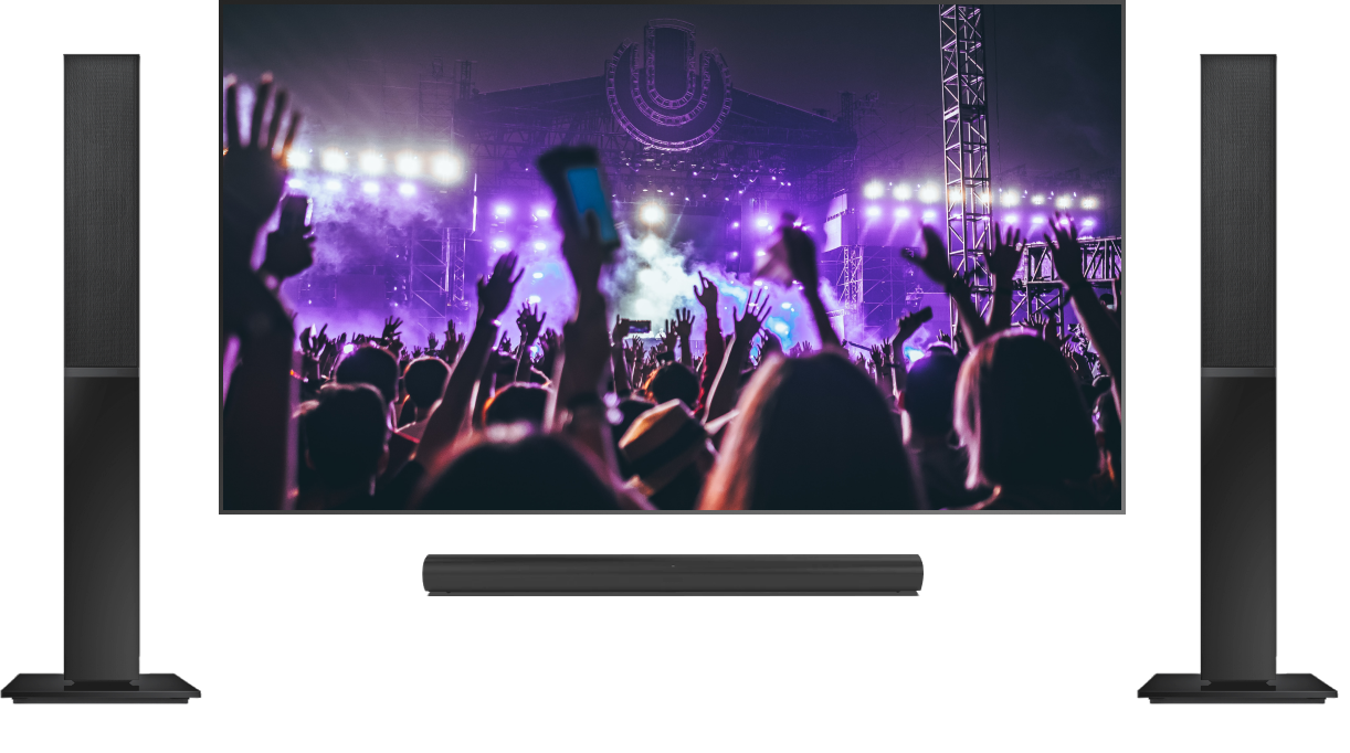 two speakers next to a TV playing a concert