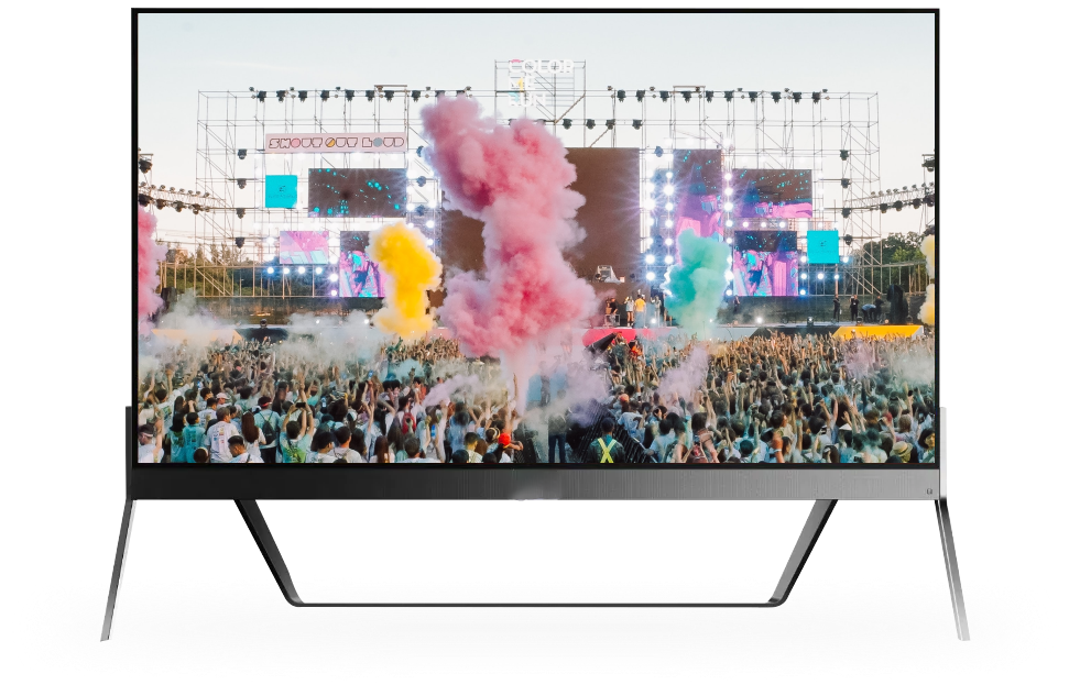 Large television displaying a colorful concert with a big crowd