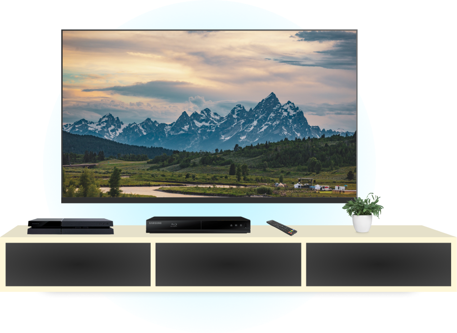 Television set-up with Playstation 4 and a Blu-Ray player. Tv has an image of a mountain range and river